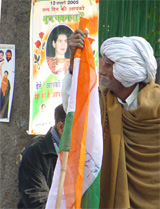 A supporter of a ticket-seeker looks at a poster congratulating Priyanka Gandhi on her birthday outside 10 Janpath in New Delhi on Wednesday. 