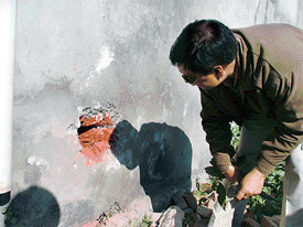 A hole in a wall of Allahabad bank being examined by a police official in Ludhiana on Thursday
