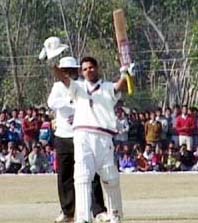Delhi batsman Shikir Dhawan waves to the crowd after scoring a century against Himachal Pradesh in the one-day Ranji Trophy match at Nadaun