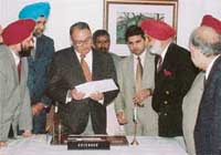 President of the Chandigarh Golf Club Col A.P. Singh (third from right) hands over a cheque of the club for Rs 5 lakh to Governor of Punjab S.F. Rodrigues, for tsunami relief fund in Chandigarh on Friday.