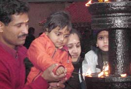 A little devotee lights an agarbatti to mark Makaravilakku Puja at Sree Ayyappa Temple, Sector 47, Chandigarh, on Friday.