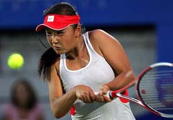 Shuai Peng of China returns to Australia's Alicia Molik during their semifinal match at the Sydney International tennis tournament on Friday