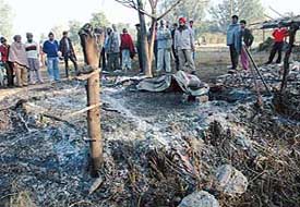 Mullanpur villagers near the place where stood a jhuggi and was destroyed in a fire on Saturday. 