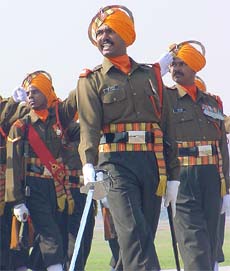 A Captain of the Sikh Regiment salutes while marching past at the 57th Army Day parade in Delhi