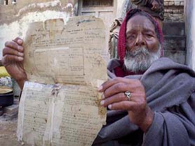 Joginder Singh displays the letter awarding "Jangi Inam" to his father by the British at his house in Nabha.