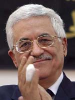 Newly installed Palestinian leader Mahmud Abbas applauds after his swearing-in as Palestinian President in Ramallah on Saturday