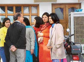 Relatives of Mr D.L. Jindal, who came to attend the marriage, stand depressed outside his house in Panchkula