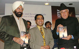 Former Jammu and Kashmir Chief Minister Farooq Abdullah releases the book 'Four Fingers and Seventeen Nails' in New Delhi on Sunday.
