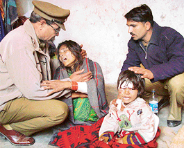 Sunaina with her daughter after the funeral of her two sons, at Kishangarh village on Monday.
