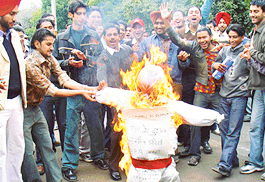 Activists of ABVP burn the effigy of UPA government at DAV College in Sector 10, @@Chandigarh, on Monday.