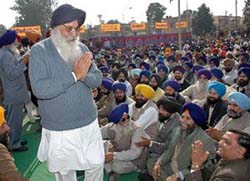 SAD chief Parkash Singh Badal greets Akali workers at a dharna organised by the party in Jalandhar on Monday. 