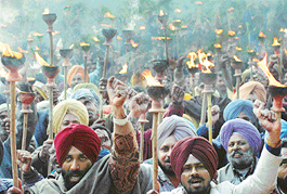 Members of the Coordination Committee of government and MC employees and workers of UT Chandigarh, take part in a torchlight procession on Tuesday. 