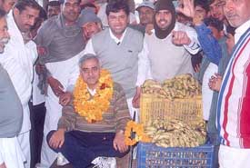 Dr Shankar Bhardwaj, Congress candidate from Bhiwani, is weighed against fruits in the Sabzi Mandi on Tuesday