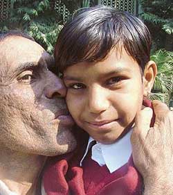 Priyanka from Gujrivas, in Rewari, gets a kiss from her grandfather, at a Press conference of bravery awardees, organised by the Indian Council for Child Welfare, in New Delhi on Tuesday. 