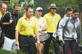 Russias Svetlana Kuznetsova is escorted by security personnel along with compatriot Anastasia Myskina