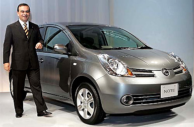 Nissan Motor's Chief Executive Carlos Ghosn poses with the automaker's all new compact car, Note, in Tokyo on Thursday