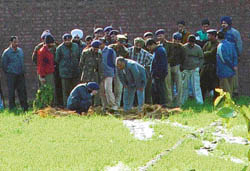 Senior Chandigarh Administration officials look at the tunnel that took Hawara and three others out of the Burail jail. 