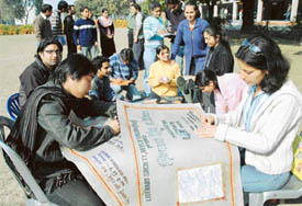 Members of the Literary Society, Department of English, Panjab University, make a poster for their play, Dance Like a Man, on Wednesday. 