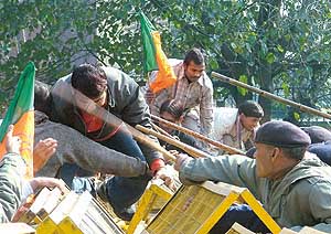 Police uses lathis to push back activists demonstrating against the Justice U. C. Banerjee Report on the Sabarmati Express Godhra fire incident, at Parliament Street, New Delhi