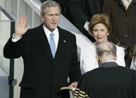 Chief Justice William Rehnquist administers the oath of office to President Bush