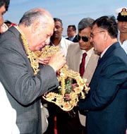 Chilean President Ricardo Lagos (L) being garlanded by Shekhar Dutt (R), Secretary, Defence Production, at Hindustan Aeronautical Ltd (HAL) in Bangalore on Saturday. 
