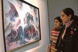 Visitors have a close look at an oil painting by Satwant Singh Sumail at an exhibition at Alliance Francaise, Sector 36, Chandigarh. 