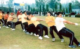 Students take part in tug of war during the annual athletics meet of Green Land Senior