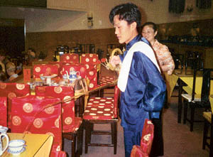 Coffee being served the traditional way through a long-stemmed pot.