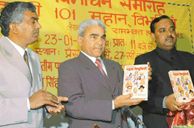 Mr Justice Pritam Paul of Punjab and Haryana High Court (centre) releases Vishav ki 101 mahan vibhutiyan book by Dr Ram Bhagat Langayan (extreme left) in Chandigarh on Sunday.