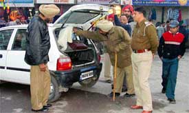 Policemen check vehicles as part of security measures for the Republic Day celebrations, in Ludhiana on Sunday