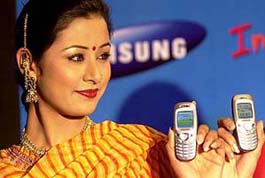 A model displays a new range of Samsung mobile phones launched by a multinational company which have the facility of SMS and predictive text in many regional Indian languages in New Delhi 