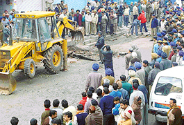Demolition drive by the Enforcement Department of UT Administration in progress at Grain Market, Sector-26, Chandigarh, on Monday. 
