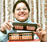 Shikha Sood displays an abacus learning kit in Chandigarh.