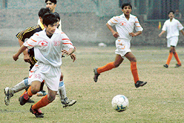 Manoj of the CFA on the way to score a goal against Mehar Academy Kurali in the final match of Chandigarh junior soccer cup at Sector-42, Chandigarh, on Monday.