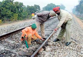 Cops and keyman Ram Bharose point towards the fracture on the Ludhiana-Dhuri rail track on Monday