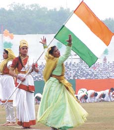 Children carry the Tricolour without the Ashok Chakra under the gaze of the Chief Minister and other dignitaries at a Delhi Government Republic Day function in the Capital