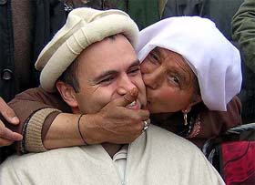 A woman supporter of the National Conference kisses party president Omar Abdullah during a campaign rally in Srinagar on Tuesday
