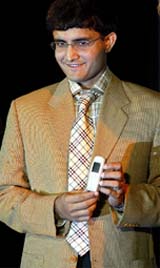 Tata brand ambassador and captain of the Indian cricket team Saurav Ganguly shows a new Tata mobile phone during its launch in Kolkata