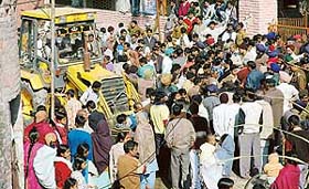 Residents of Dadu Majra Colony gherao a Chandigarh Housing Board (CHB) team in protest against a demolition drive