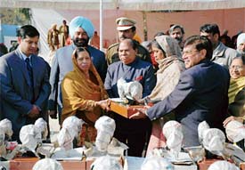 Ch. Jagjit Singh, Minister for Local Government, Labour and Employment, Punjab, distributes sewing machines among the needy at the Republic Day function at the Government College for Boys