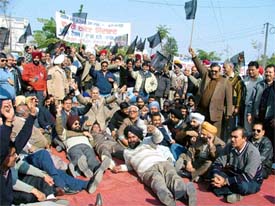 Members of industrial associations,led by the United Cycle and Parts Manufacturers Association, stage a protest against service tax at the Central Excise office in Ludhiana