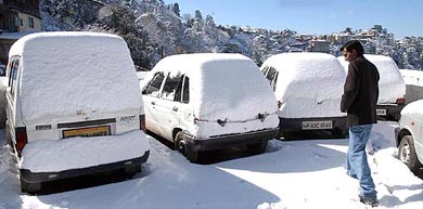 A view of a car parking after a fresh snowfall in Shimla on Friday