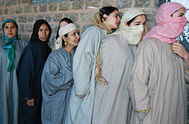 Kashmiri women queue up outside a polling station to vote in the civic-bodies poll at Handwara on Saturday.