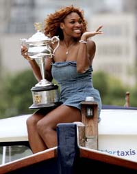 Serena Williams of the USA, winner of the womens singles title at the Australian Open, poses with the trophy on a water taxi in the Yarra river in Melbourne