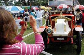 A woman captures the picture of a Renault car of year at the Vintage Car Show - 2005 in Kolkata on Sunday morning