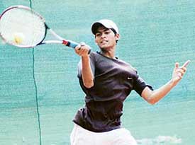 Tanvir Ashiq of Pakistan returns a shot against Navinder Pal Singh in an Indo-Pak friendship tennis match at YMCA