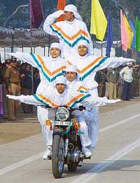 Women police personnel perform stunts on motorcycles at a show during the Republic Day parade in Chandigarh on Wednesday