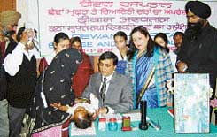 Dr Narottam Dewan examines a child at a free medical camp in Ludhiana
