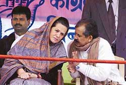 Congress President Sonia Gandhi has a word state party leader Ram Jatan Sinha during an Assembly election campaign in Buxor, Bihar, on Monday.