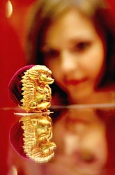 A visitor admires a gold hedgehog